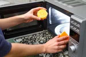 https://theorganicmaids.com/wp-content/uploads/2023/08/cleaning-microwave-with-a-lemon-and-sponge-300x200-1.jpg